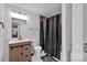Bright bathroom featuring a vanity with wood cabinets and a shower with a curtain at 140 Wandering Ln, Bessemer City, NC 28016