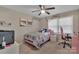 This bedroom features a ceiling fan, window, and a comfy pink bed with pink decor at 140 Wandering Ln, Bessemer City, NC 28016