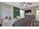 This bedroom features a large TV, ceiling fan, closet, and an accent wall at 140 Wandering Ln, Bessemer City, NC 28016