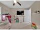 This bedroom features a ceiling fan, large TV, and a bed at 140 Wandering Ln, Bessemer City, NC 28016