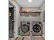 Laundry room featuring modern stainless steel washing machines and storage shelves at 140 Wandering Ln, Bessemer City, NC 28016