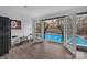 View of bright backyard pool from inside, featuring open French doors and dark wood floors at 140 Wandering Ln, Bessemer City, NC 28016