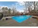 Outdoor pool surrounded by a concrete deck, complemented by a diving board and safety handrails at 140 Wandering Ln, Bessemer City, NC 28016