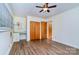 Bright bedroom features a ceiling fan, wood floors, built-in desk, and spacious closet at 1409 Sherwood Dr, Kannapolis, NC 28081