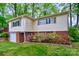 Charming home with brick accents, flowering shrubs, and green lawn, creating a welcoming exterior at 1409 Sherwood Dr, Kannapolis, NC 28081