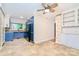 Open kitchen features blue cabinets, stainless steel appliances, and a dining area with tile flooring at 1409 Sherwood Dr, Kannapolis, NC 28081