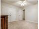 Bedroom featuring carpeted floor, ceiling fan, double closet and multiple doors at 1581 Arborgate Dr, Rock Hill, SC 29732