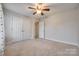 Spacious bedroom with a ceiling fan, double closets and neutral carpet at 1581 Arborgate Dr, Rock Hill, SC 29732