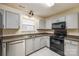 Well-lit kitchen with light gray cabinets, black appliances, and neutral countertops at 1581 Arborgate Dr, Rock Hill, SC 29732