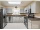 Bright kitchen with stainless steel appliances, light grey cabinets, and tiled flooring at 1581 Arborgate Dr, Rock Hill, SC 29732