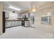 The kitchen has tile floors, grey cabinets, and black appliances at 1581 Arborgate Dr, Rock Hill, SC 29732