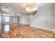 Open living room with hardwood floors, a ceiling fan, staircase, and neutral wall paint at 1581 Arborgate Dr, Rock Hill, SC 29732
