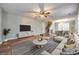 Open-concept living room and dining area with modern furnishings, hardwood floors, and neutral decor at 1581 Arborgate Dr, Rock Hill, SC 29732