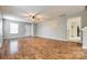 Living room featuring hardwood floors, neutral paint, ceiling fan, and a view to the front door at 1581 Arborgate Dr, Rock Hill, SC 29732