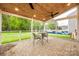 Cozy screened-in patio with a wooden ceiling, brick floor and table/chair set for outdoor relaxation at 1581 Arborgate Dr, Rock Hill, SC 29732