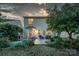 Relaxing backyard with patio, seating, and lush plantings at twilight at 16524 Kettlewell Ln, Charlotte, NC 28277