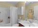 Well-lit bathroom featuring a vanity with mirror and a shower/tub combo at 16524 Kettlewell Ln, Charlotte, NC 28277