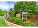 Stone sign for Southampton community surrounded by lush landscaping and colorful flowers at 16524 Kettlewell Ln, Charlotte, NC 28277