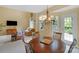 Dining space with modern chandelier and seamless flow to the living room, perfect for entertaining and Gathering meals at 16524 Kettlewell Ln, Charlotte, NC 28277