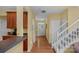 Bright entryway with hardwood floors, a staircase, and a view into the kitchen area at 16524 Kettlewell Ln, Charlotte, NC 28277