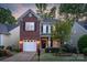 Beautiful two-story home featuring a brick accent wall, attached garage, and manicured front lawn at 16524 Kettlewell Ln, Charlotte, NC 28277