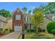 Charming two-story home with brick facade, lush landscaping, and attached garage at 16524 Kettlewell Ln, Charlotte, NC 28277