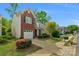 Charming two-story home with brick facade, lush landscaping, and attached garage at 16524 Kettlewell Ln, Charlotte, NC 28277