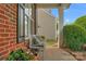Cozy front porch seating area with potted flowers and decorative pillows at 16524 Kettlewell Ln, Charlotte, NC 28277