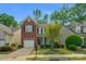 Charming home with brick accents, manicured lawn, and attached garage at 16524 Kettlewell Ln, Charlotte, NC 28277