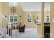 Bright living room featuring a vaulted ceiling, many windows, and stylish decor at 16524 Kettlewell Ln, Charlotte, NC 28277