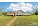 Lush green backyard with an exterior view of the house and a wooden deck at 1676 Starmount Cir, Lancaster, SC 29720