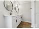Bright bathroom featuring a double vanity with modern sinks and fixtures, with new laminate flooring at 1676 Starmount Cir, Lancaster, SC 29720