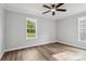 Bedroom with ample natural light from two windows, enhancing its neutral walls and modern flooring at 1676 Starmount Cir, Lancaster, SC 29720