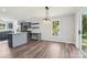 Open dining area boasts an island, and stylish light fixture above the table at 1676 Starmount Cir, Lancaster, SC 29720