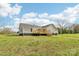 Rear view of home featuring a deck overlooking a spacious green lawn at 1676 Starmount Cir, Lancaster, SC 29720