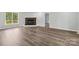 Bright living room featuring a cozy brick fireplace and hardwood floors at 1676 Starmount Cir, Lancaster, SC 29720
