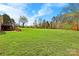 Expansive backyard features a lush lawn, mature trees, and plenty of space for recreation and relaxation at 173 Chestnut Grove Rd, Statesville, NC 28625