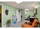 A finished basement with shelving, a desk, seating, and access to a bathroom at 173 Chestnut Grove Rd, Statesville, NC 28625