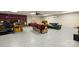 Finished basement with gray epoxy floors, a brick fireplace and multiple seating areas at 173 Chestnut Grove Rd, Statesville, NC 28625