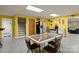 The basement features a retro kitchen setup with yellow walls, speckled epoxy flooring, and a dining area at 173 Chestnut Grove Rd, Statesville, NC 28625