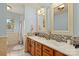 Bathroom featuring double sink, tiled shower, and a large mirror at 173 Chestnut Grove Rd, Statesville, NC 28625