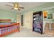 This is a bright bedroom with a wooden bed frame, a bookcase, and a doorway to a bathroom at 173 Chestnut Grove Rd, Statesville, NC 28625