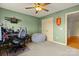 A bedroom with green walls and a ceiling fan, with a cozy beanbag chair at 173 Chestnut Grove Rd, Statesville, NC 28625