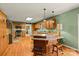Traditional kitchen featuring wooden cabinets, granite countertops, island with breakfast bar and stainless-steel appliances at 173 Chestnut Grove Rd, Statesville, NC 28625