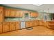 Bright kitchen featuring ample wooden cabinetry, granite countertops, stainless steel appliances, and wood flooring at 173 Chestnut Grove Rd, Statesville, NC 28625