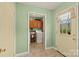 A laundry room with sage green walls, tile floors, cabinetry, and a view of the backyard at 173 Chestnut Grove Rd, Statesville, NC 28625
