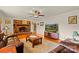 Inviting living room with hardwood floors, a brick fireplace, comfortable furniture, and a ceiling fan with light fixture at 173 Chestnut Grove Rd, Statesville, NC 28625