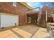 Brick home featuring a garage, patio, and upper-level deck with stairs, set against a lush backyard at 173 Chestnut Grove Rd, Statesville, NC 28625