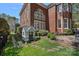 Beautiful backyard featuring a playhouse, well-manicured lawn, and a handsome brick home at 18418 Turnberry Ct, Davidson, NC 28036