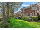Expansive backyard featuring a lush lawn, mature trees, and a charming patio area perfect for outdoor entertaining at 18418 Turnberry Ct, Davidson, NC 28036